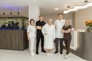 Orthopedic surgeon Linas Zeniauskas with his patient and Gijos Klinikos rehabilitation team (nurse, physiotherapist, scrub nurse) in the clinic’s rehabilitation ward, Lithuania.