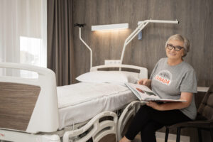 Patient relaxing and reading in private hospital room gijos clinic lithuania
